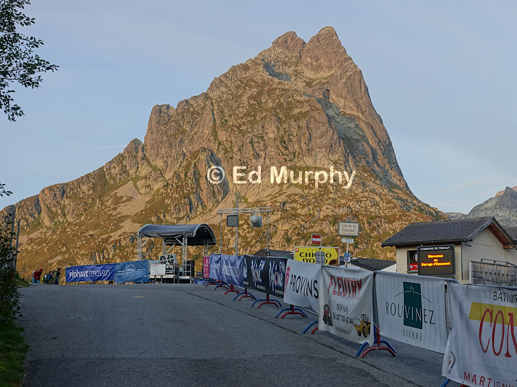 First sun on the Aiguilles du Vent on bicycle race day at the Emosson dam